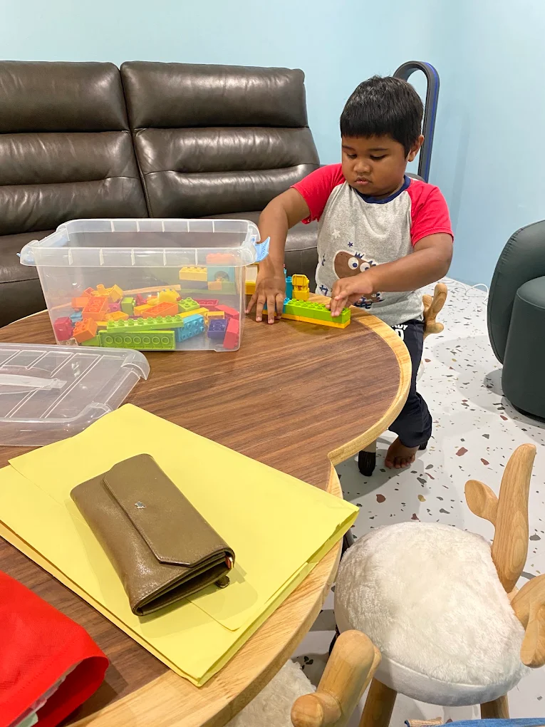Child using building blocks during developmental play observation