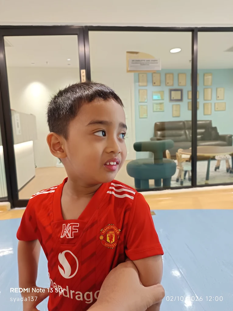 Child in clinic play area outside consultation room
